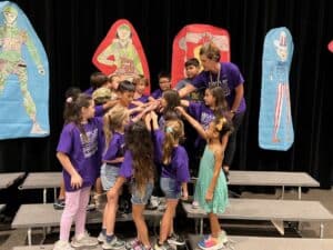 Students doing a group cheer.