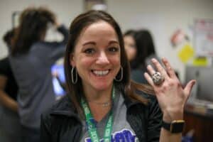 Teacher posing with replica World Series Ring
