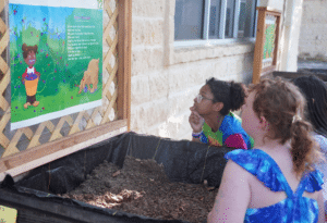Students interacting with part of the Story Garden.