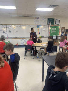 Students getting instructed by their teacher.