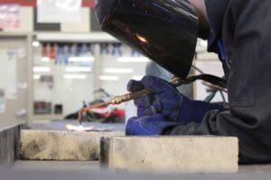 Student practices welding.