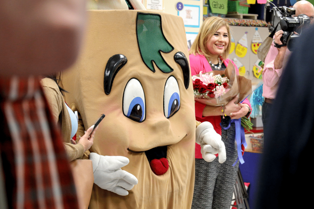 Finalist, Carol Hudson, posing for a photo with H-E-Buddy.