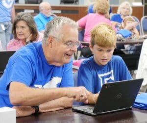 Mustang Senior and third grader looking at Dreambox work