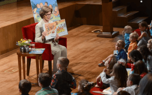 Laure Bush holds up a book to children