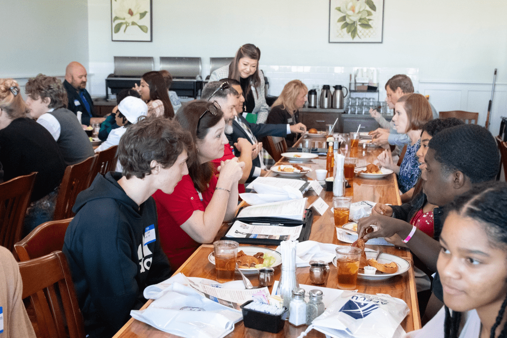 Students and professionals chat over lunch