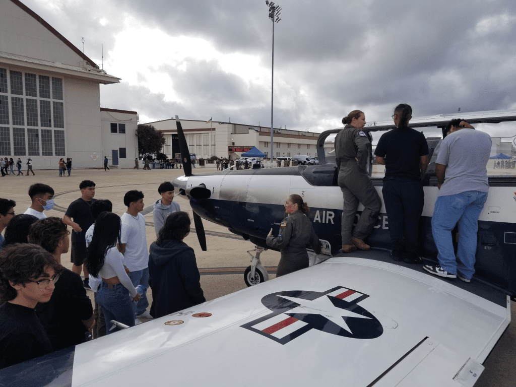 Students learning from aviation professionals
