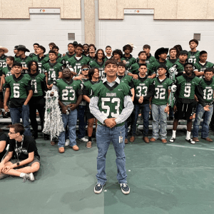 Football player poses in front of team