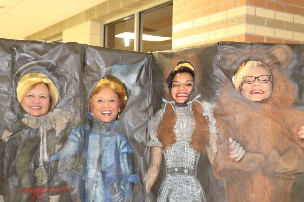 PTA Members in cardboard cut outs of Tin Man, Dorothy, Scarecrow, and Cowardly Lion