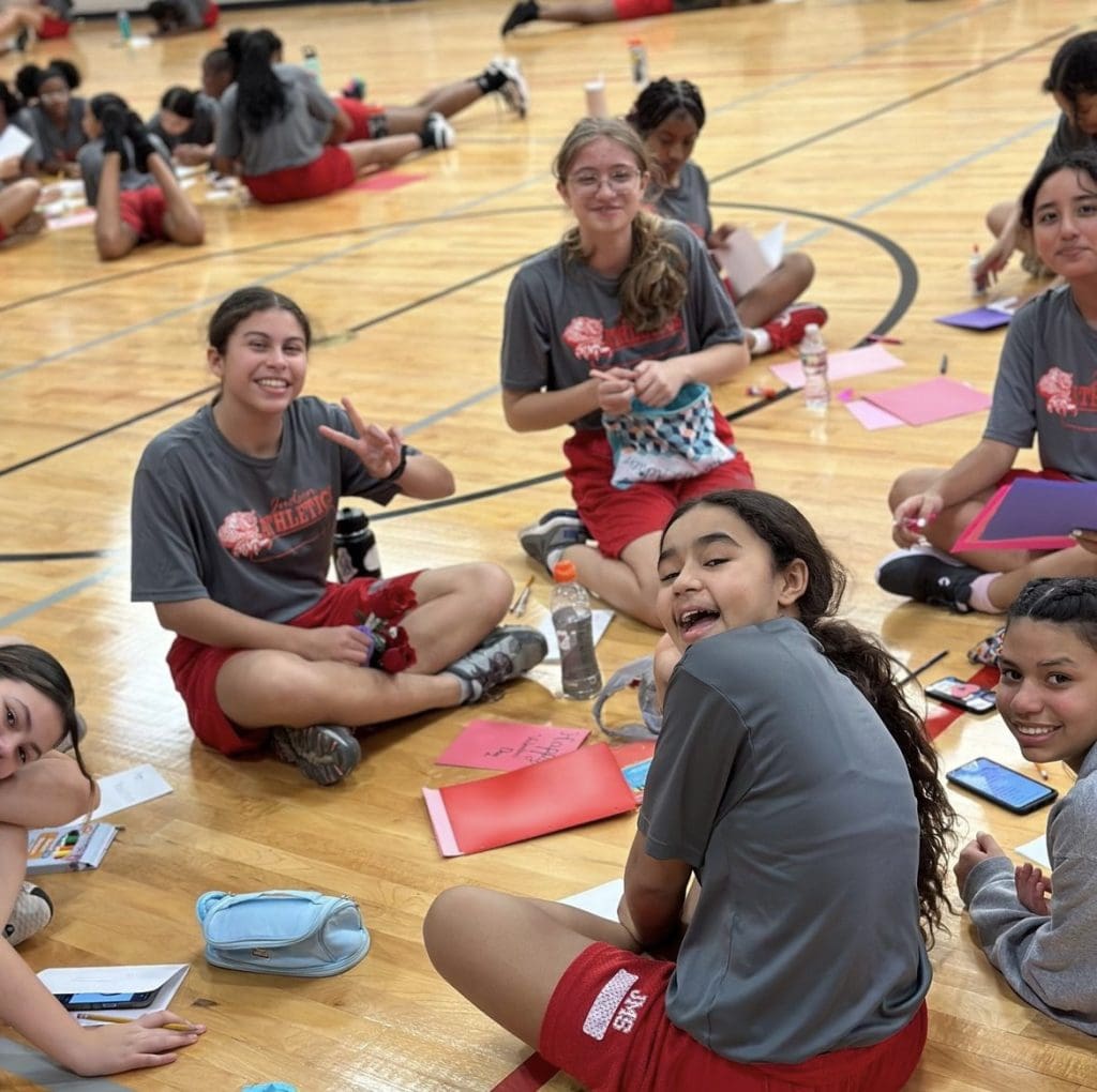 Athletes making valentines for service members