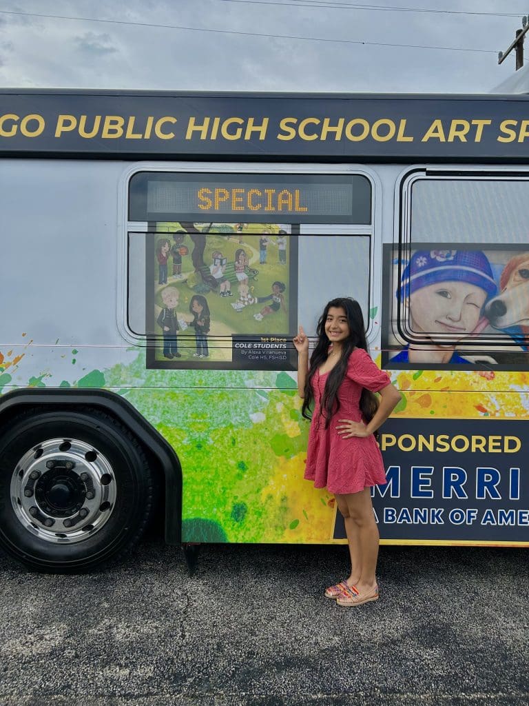 Winner poses in front of art bus