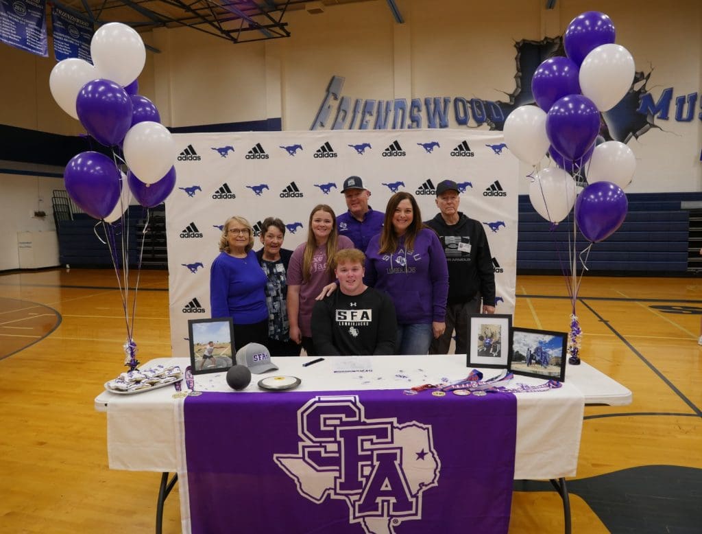 Student with family on signing day