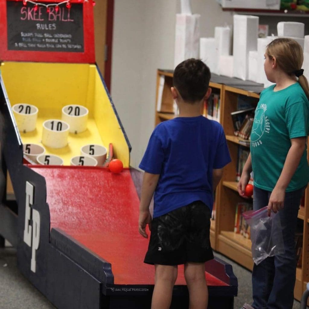 students playing bowling arcade games