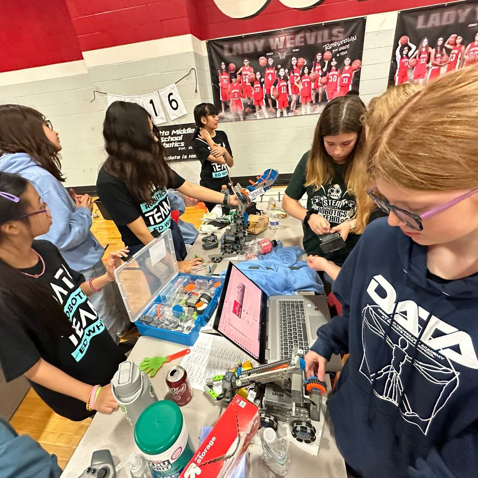robotics students work on fixing their robot