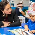 Dual Language teacher working with her student