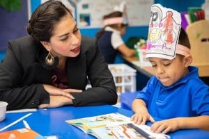 Dual Language teacher working with her student