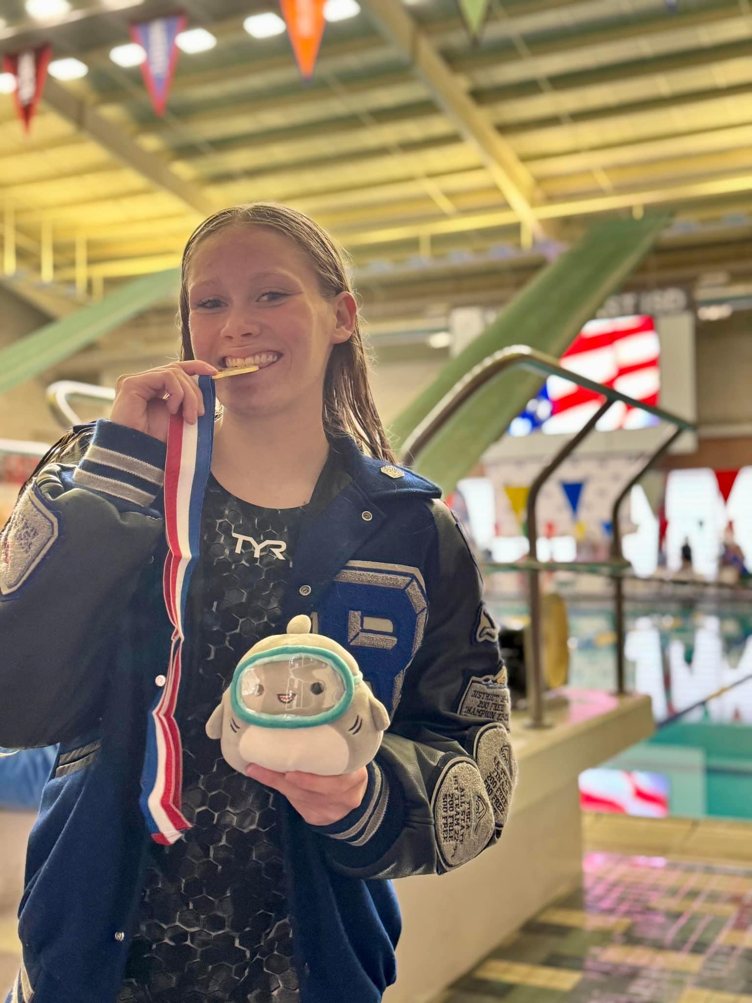 Randolph Field ISD Student Athlete, Lily Pifer, posing with her medal