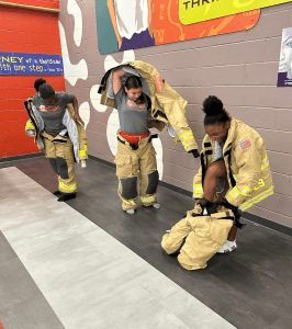 Judson MS putting on a firefighter suit