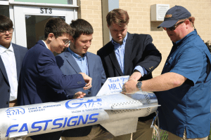 The Alamo Heights ISD students w/ teacher and rocket