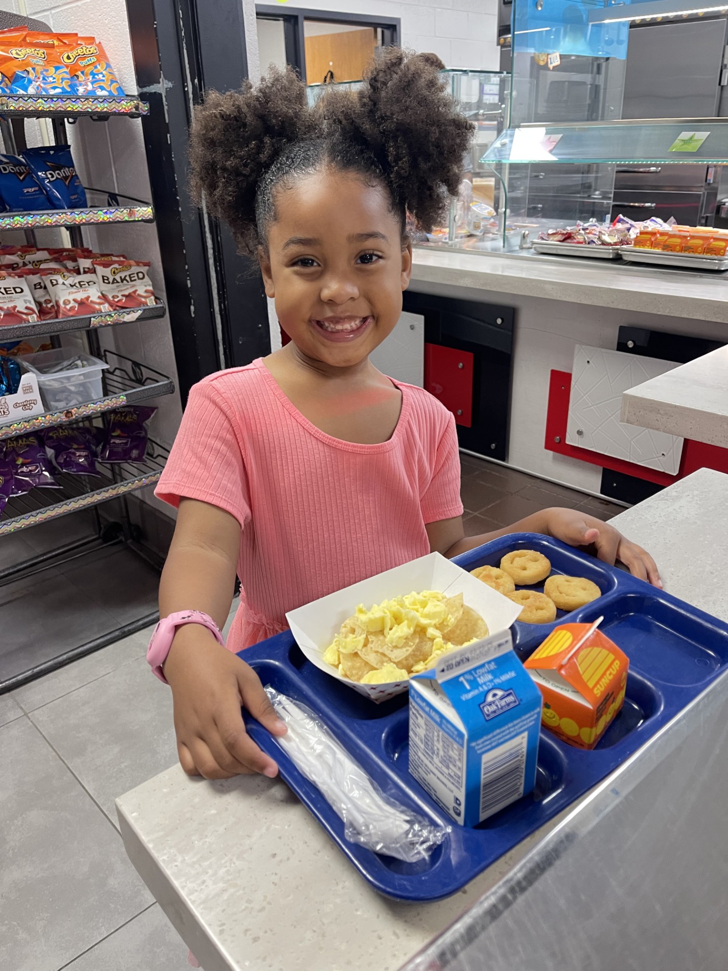 Coppell ISD Breakfast Week Girl student posing with breakfast