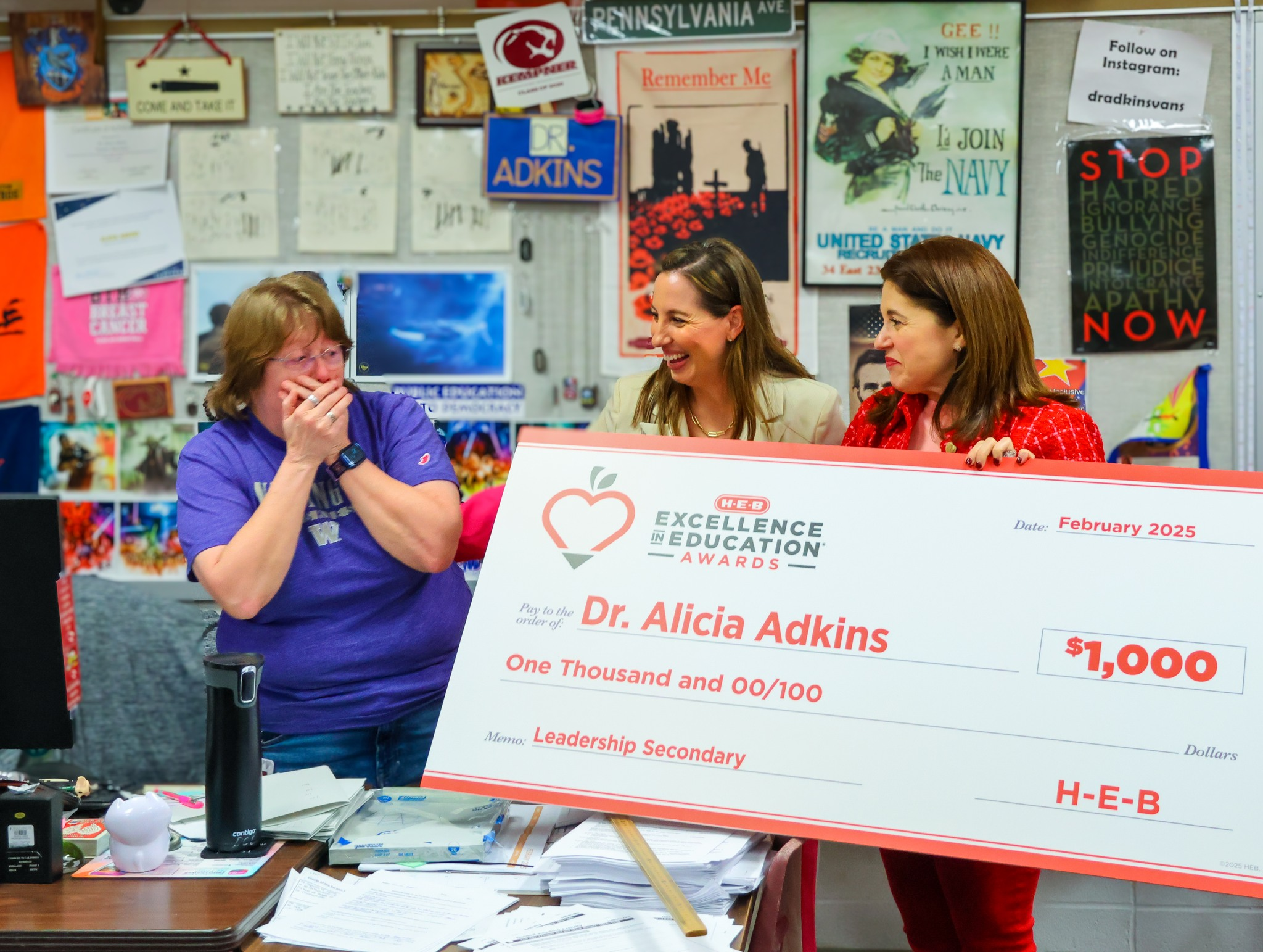 Dr. Adkins reacting to her H-E-B Excellence in Education award check