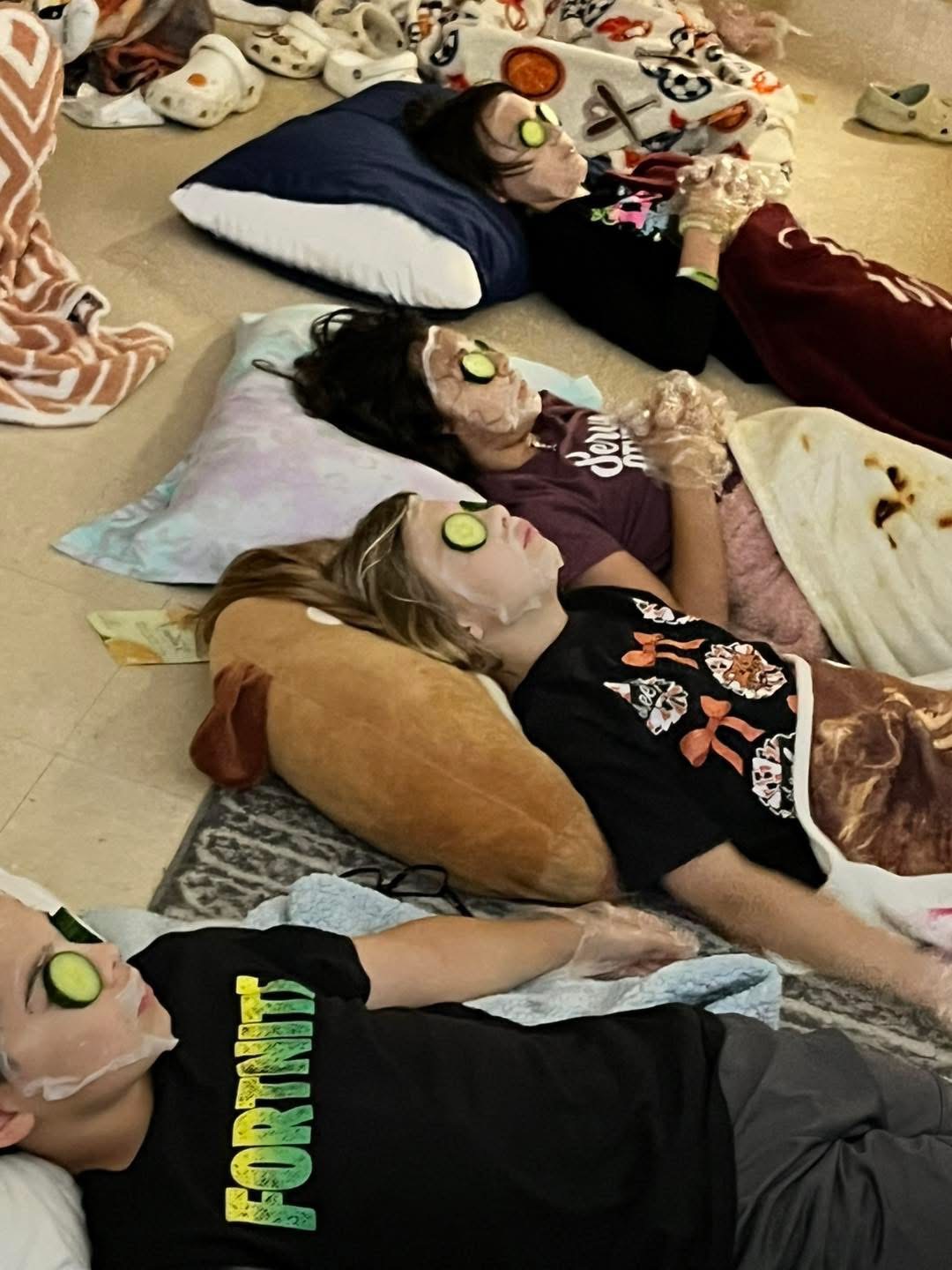 Pilot Point Elementary students lay on floor with eye masks
