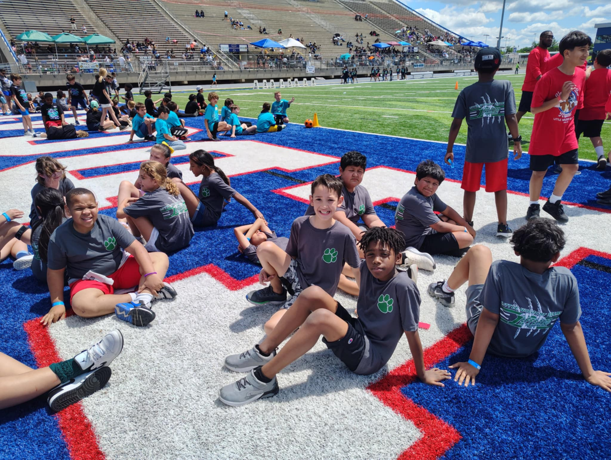 Temple ISD Students posing for a picture on the field.