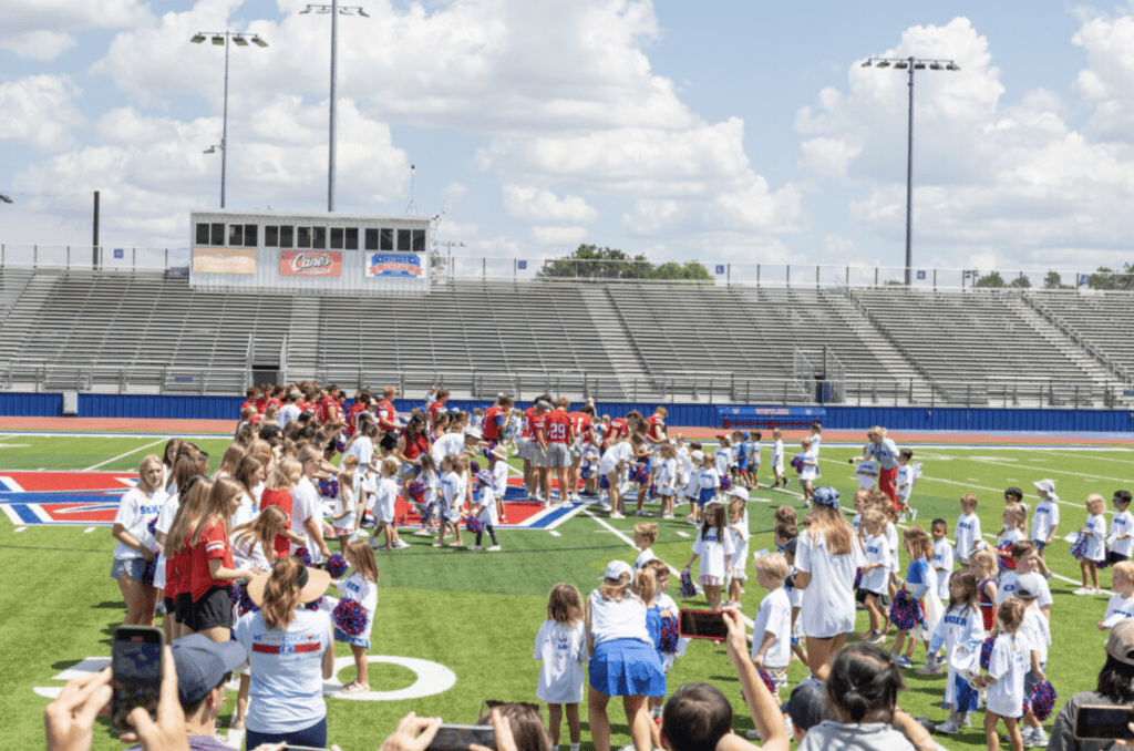 Senior football players with Kindergarten students