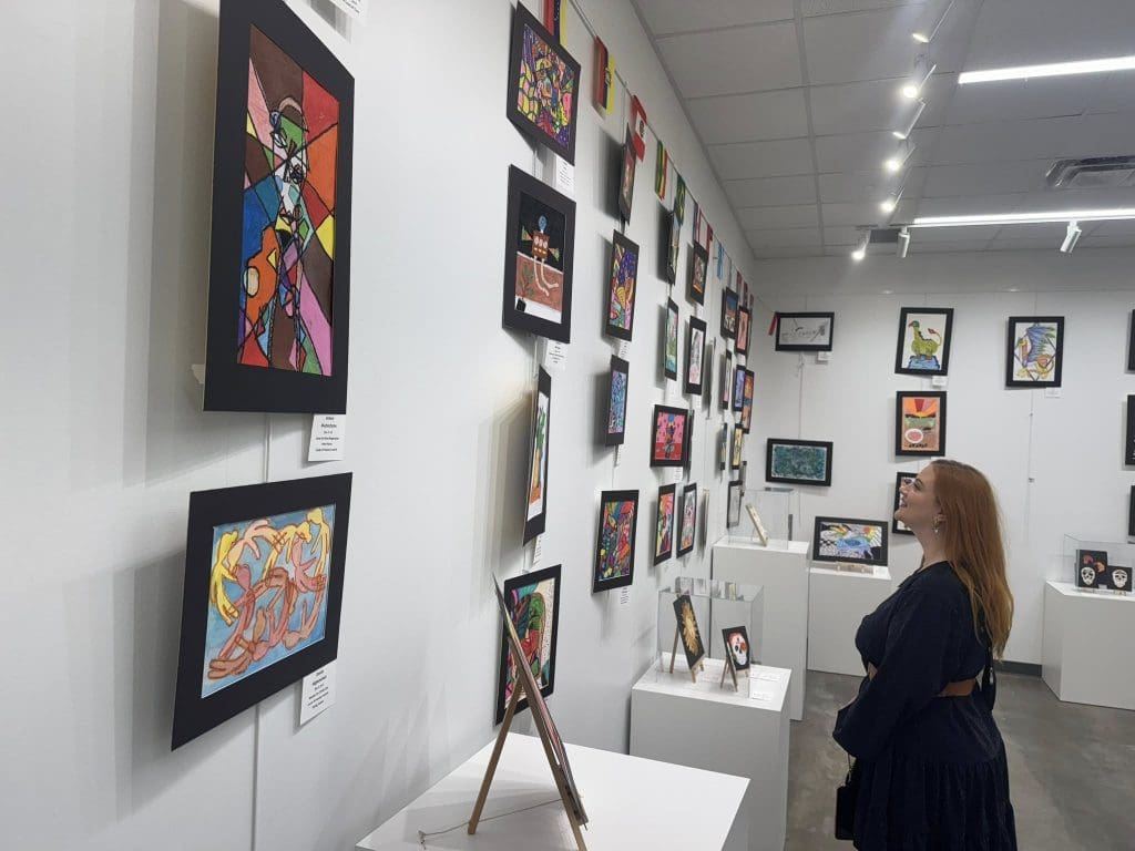 Forney ISD student analyzing art at the Hispanic Heritage Art Show