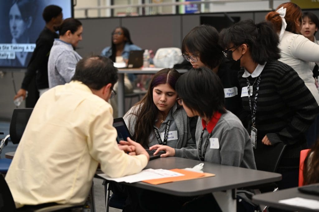 Alief students at information table