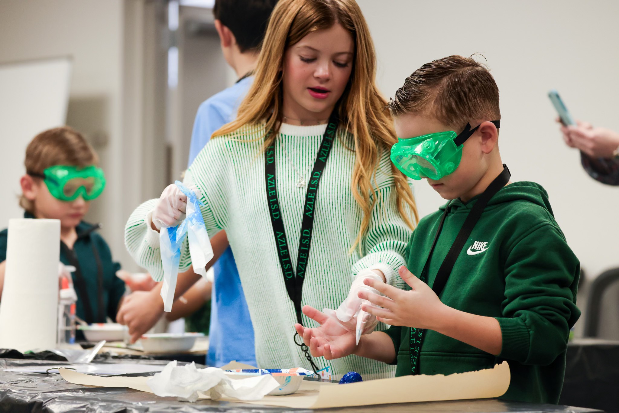Azle students performing a science experiment