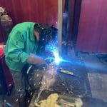Brazosport student welding a pole