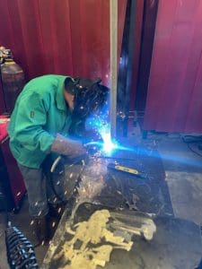 Brazosport student welding a pole