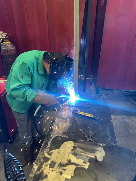 Brazosport student welding a pole