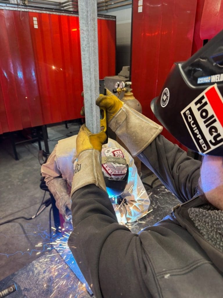 Brazosport student welding a pole