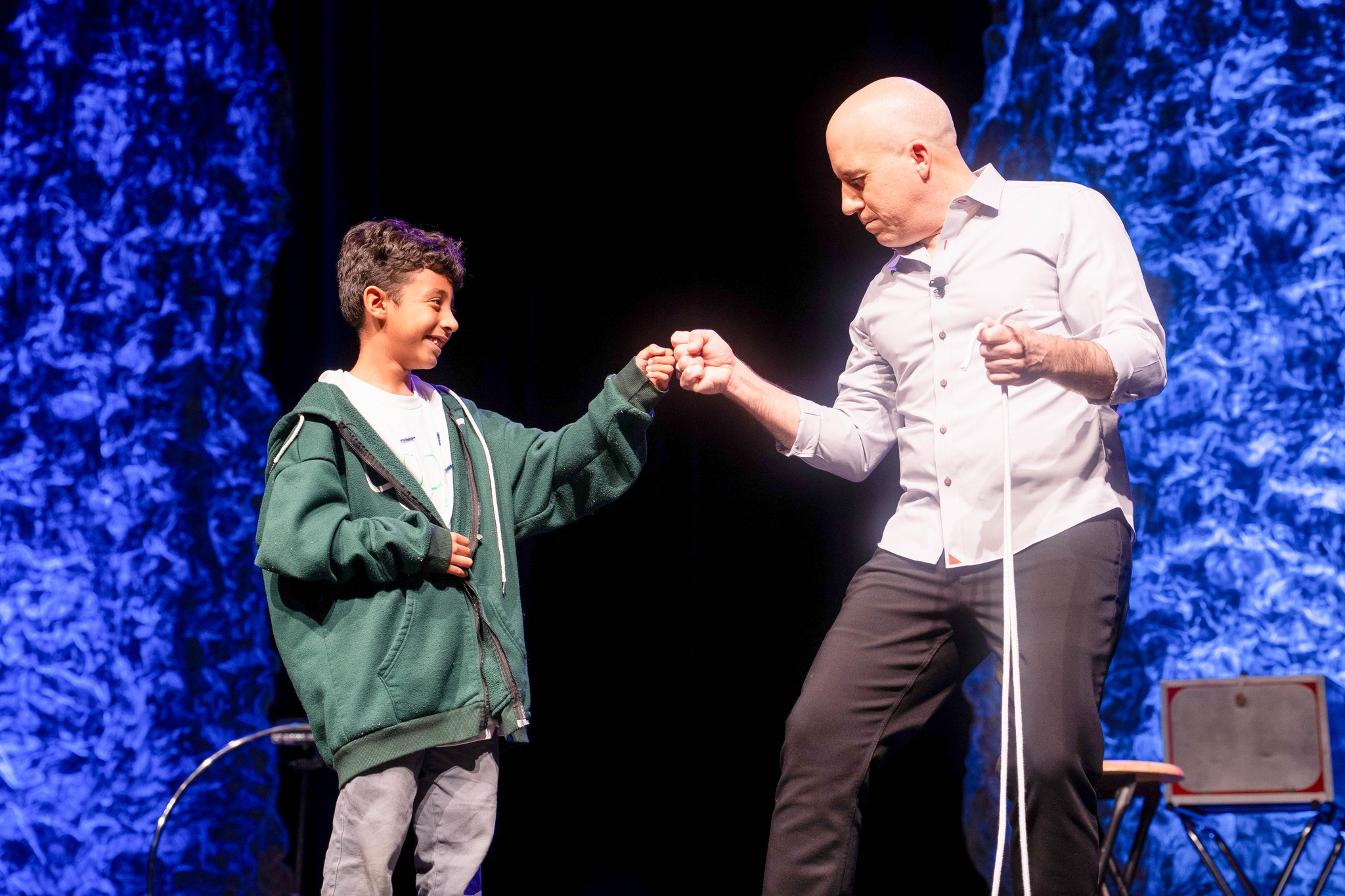 Corsicana student and Bill Blagg fist bump after performing a demonstration