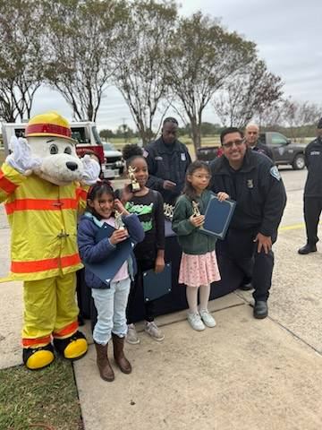 Fort Sam Houston students pose with firemen and mascot