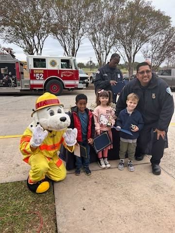 Fort Sam Houston students pose with firemen and mascot